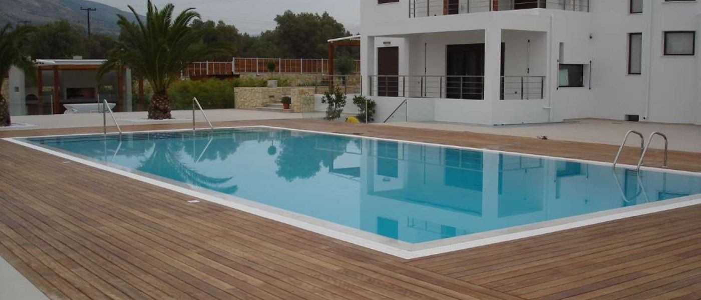 ΥΨΗΛΗ ΑΛΚΑΛΙΚΟΤΗΤΑ. Μια πισίνα με υπερχείλιση και περιβάλλον με Deck